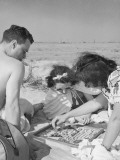 Man and Two Women Playing Chinese Checkers at Beach