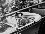 Young Couple in Vintage Soft Top Car With Golf Clubs on Back Seat