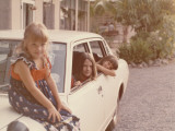 Portrait of Three Girls, One Sitting on a Car Bonnet, Two Others Inside the Car