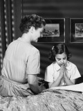Mother Watching Daughter Say Bedtime Prayers