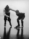 Father Teaching Son To Ice Skate on Frozen Lake