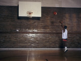 Young Boy Practicing his Basketball Shooting