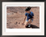 Teenage Girl Looking at Fossil Dinosaur Footprint Near Tuba City, Arizona