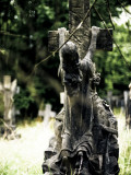 Statue of a Young Girl Jumping on Cross in Cemetery
