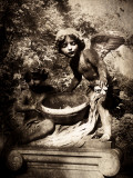 Statues of Two Young Boy Angels in Cemetery