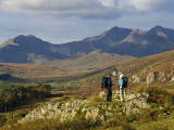 North Wales, Snowdonia; a Man and Woman Stop to Look at their Map Whilst Hiking in Snowdonia;