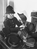 A New Recruit of the Metropolitan Police Looking at the Braided Cocked Hat Worn