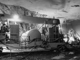 Man Working with Huge Portable Compressor Unit, Built for Refining Oil Shale