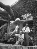 James Earle Fraser and His Wife Wheeling Massive Pieces of the Sculpture onto an Outside Platform