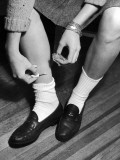 Teenage Girl Using Clear Nail Polish to Hold Up Her Socks