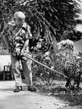 Older Man Gardening, Using a Hoe Premium Photographic Print