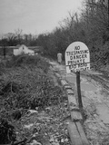 Census Taker Gwenn Brandenburg Walking Down a Muddy, Well Posted Road