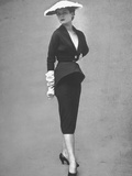 Model Posing in Black Cocktail Dress Featuring a Deep V Neck Which Almost Goes to the Waist