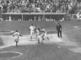 Subway Series: Yankees Standing in the Dugout Watching the Dodgers around Homeplate