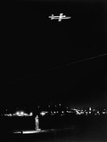 Distant View of Don Yearout Operating a Toy Jet Plane at Night