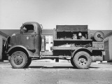 Side View of Truck Carrying Air Compressor, Pile Driver and Circular Saw