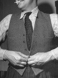 A Man Buttoning Up His "Waistcoat", in America We Call it a Vest
