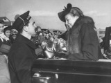 Naval Officer Helping Eleanor Roosevelt Out of Convertible