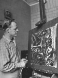 Painter Millard Sheets Looking over One of His Canvases