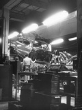 Employees Working on Cars as They Move Down Assembly Line