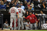 Cardinals v Brewers - Milwaukee, WI - Oct. 16: David Freese, Yadier Molina and Rafael Furcal