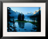 Scenic View of the Lake Surrounded by Evergreens and Snow-Capped Mountains