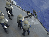 A U.S. Sailor Fires a .50-Caliber M2HB Machine Gun Aboard USS Frank Cable