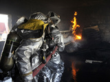 Firefighters Extinguish a Fire in a Training Room During Live Burn Training