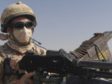A British Army Soldier Mans a Machine Gun Mounted on Top of a Land Rover
