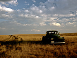 A Landscape of an Old Farm Truck in a Field at Sunset