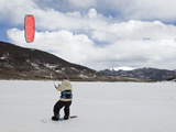 A Man Snow Kiteboarding on a Frozen Dillon Reservoir