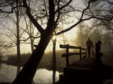 Buy Silhouette of a Man Pushing a Bicycle Along Lake Banyoles at AllPosters.com