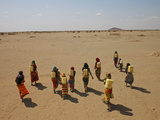 Gabra Women Carrying Heavy Jerry Cans Filled with Murky Water