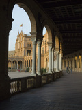 Three People Walking Underneath a Colonnade at the Plaza De Espana