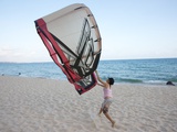 A Young Woman Runs on the Beach with Her Kite in Mui Ne, Vietnam