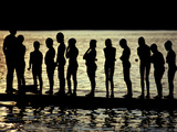 Buy A Backlit View of Swimmers on a Dock on Lake Banyoles at AllPosters.com