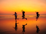 Silhouetted Children Playing on the Beach at Sunset
