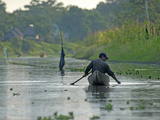Buy A Yanayacu Indian Fisherman Floats His Canoe in the Yanayacu River at AllPosters.com