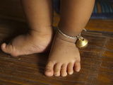 Vietnamese Infant's Feet with a Bell around the Ankle