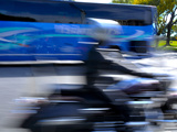 Buy A Speeding Motorcycle Zooms by a Bus at AllPosters.com