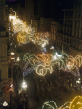 Buy Festive Lights Span across Buildings over Pedestrians on the Street at AllPosters.com