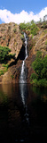 A Waterfall Tumbles Down a Rugged Escarpment Cliff Face into a Lagoon