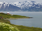 A Lonely House on the Shore, Backed by Snowy Mountains Photographic Print