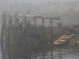Rowboat in the Rocks and a Pier in Early Morning Fog