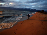 A Man Walks Along the Shore of Lake Baikal
