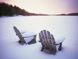 Two Snow-covered Chairs Outdoors