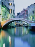 Bridge above a channel in Venice, evening shot