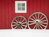Wagon Wheels on Snow Against Stable