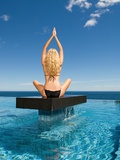 Buy Woman practicing yoga on a platform at AllPosters.com