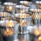 Many Votive Candles in Silver Holders